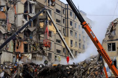 Russian missile strike destroyed residential building, Dnipro, Ukraine. Rescuers are looking for people under rubble of house, rescue equipment, fire. Russian war in Ukraine, Dnepr