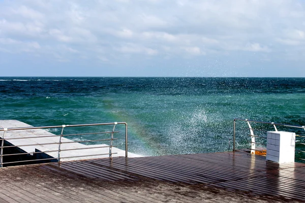 Waves , surf and rainbow  in the sea. — Stock Photo, Image