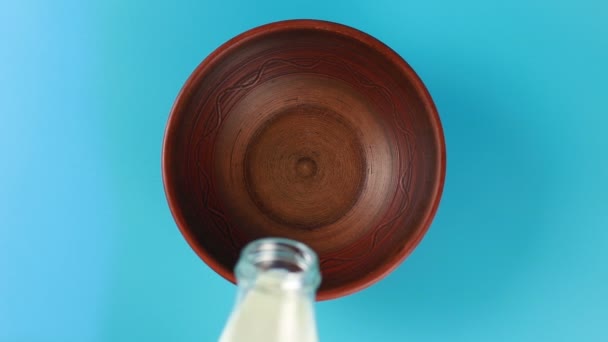 Le lait est versé dans un bol d'une bouteille — Video