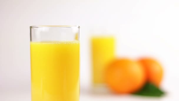 Refocusing with orange juice in a glass — Stock Video