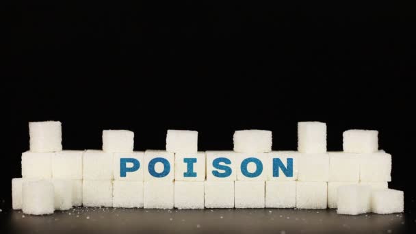 Mans hand puts sugar cubes on which is inscriptionthe word poison — Stock Video
