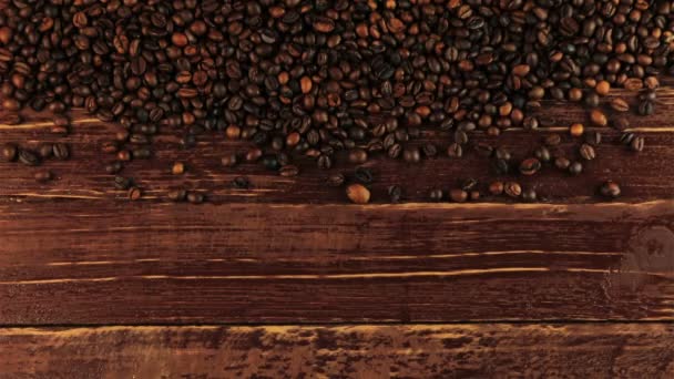 Young man puts a cup of coffee beside arranged roasted black coffee beans on brown wooden table — Stock Video