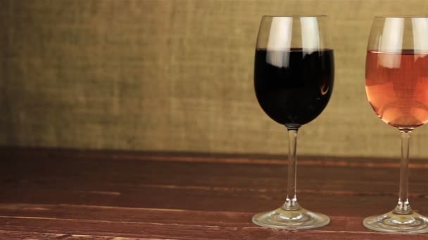 White wine, rose wine and red wine on wooden table — Stock Video