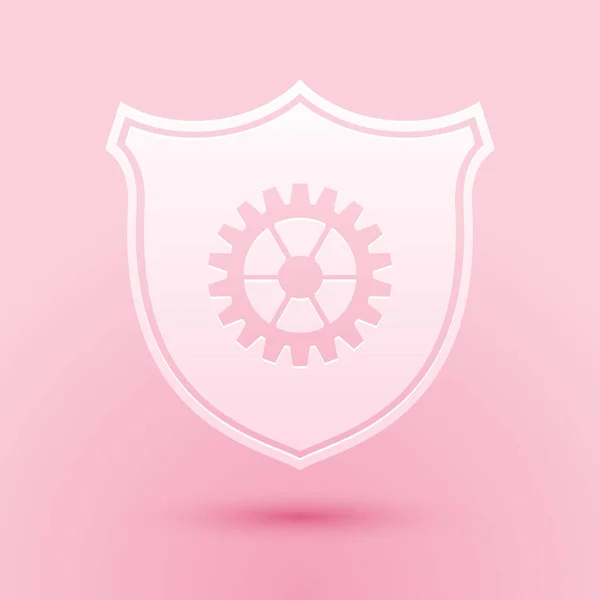 ピンクの背景に絶縁されたギアアイコンを持つペーパーカットシールド 紙のアートスタイル ベクトル — ストックベクタ