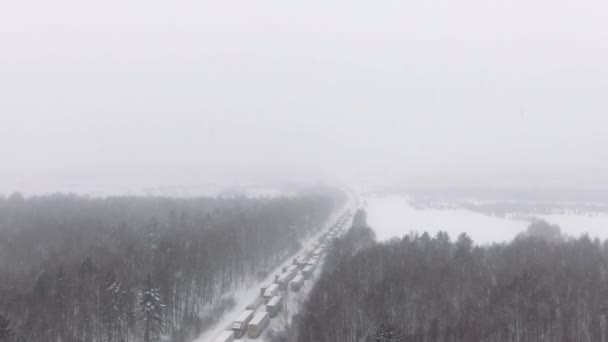 Náklaďáky uvízly v zácpě na zasněžené dálnici. — Stock video