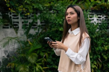 Genç bir kadın, arkadaşlarıyla kutlama yapmak için cep telefonundan sürpriz haberler alıyor.