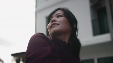 Genç Asyalı kadın sporcu vücudunu esnetiyor. Sabah koşuya ya da antrenmana hazırlanıyor.