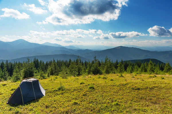 Summer vacation in the mountains with a tourist tent with beautiful views around