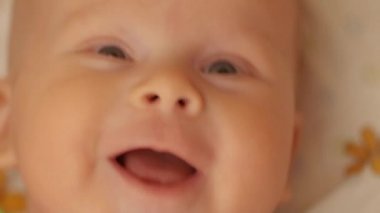  baby smiles in bed
