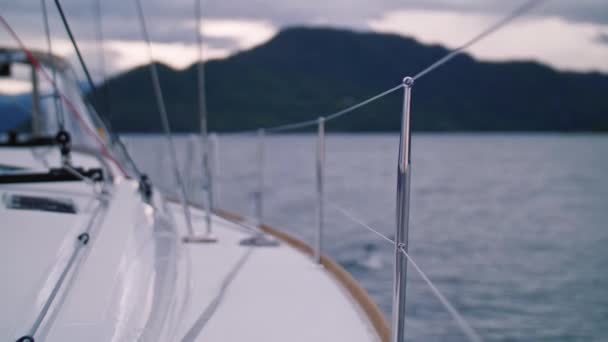 Vista no convés traseiro do iate esporte branco que flutua na viagem de superfície lisa de água do mar clara no navio — Vídeo de Stock