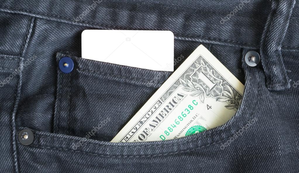 Blank business card and one dollar  in a pocket of gry worn out jeans.