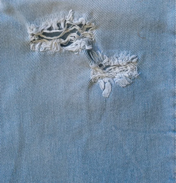 Albastru vechi rupe blugi closeup — Fotografie, imagine de stoc