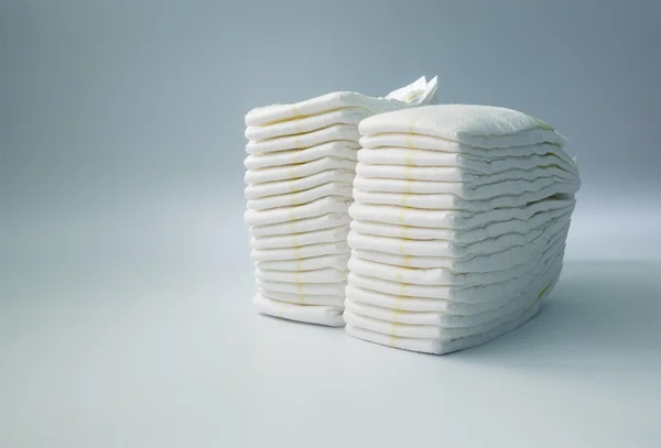 Diapers stacked in a piles in the child room. — Stock Photo, Image