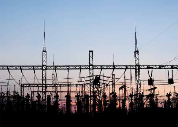 Electrical substation silhouette on the dramatic sunset background.