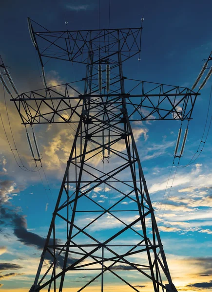 The silhouette of the evening electricity transmission pylon Royalty Free Stock Images
