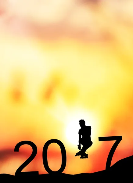 Silhouette man jumps to make the word Happy New Year 2017 with sunrise. — Stock Photo, Image