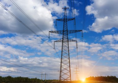 Kule güç hatları ve elektrik telleri, günbatımı bulutlara.