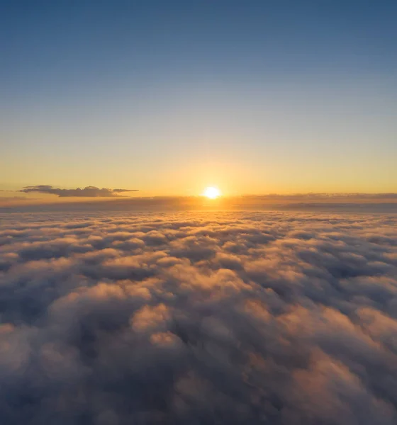 Beautiful sunrais cloudy sky from aerial view. Airplane view above clouds
