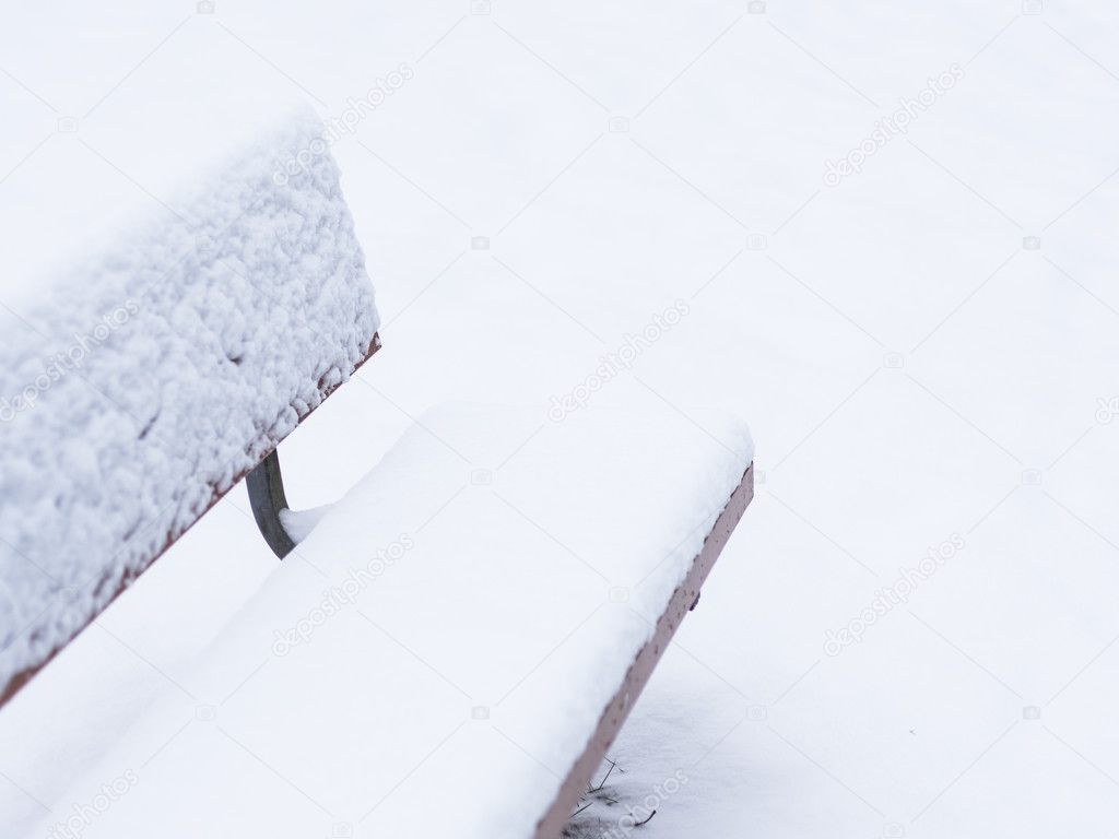 Park Bench Covered in Snow
