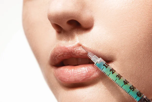 Woman gets an injection in her lips — Stock Photo, Image