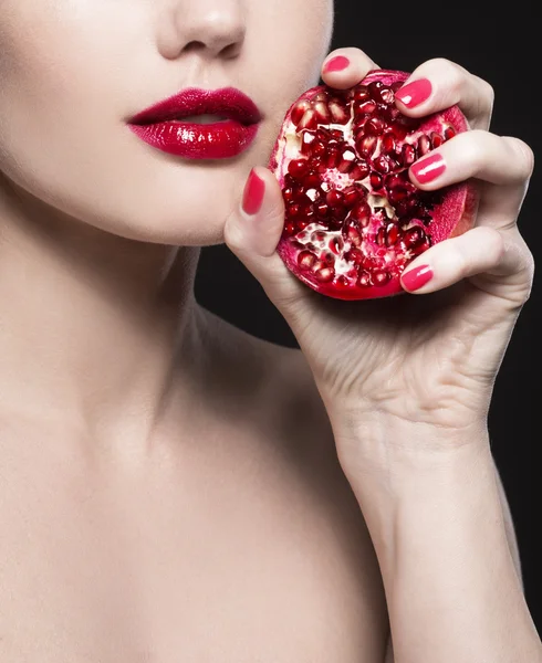 Girl with red pomegranate in a hand — Stock Photo, Image