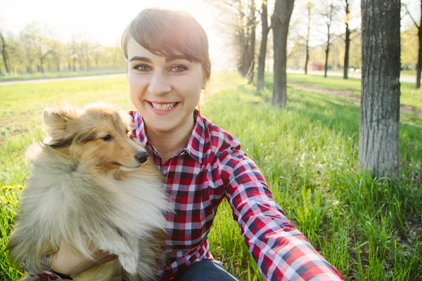 Young woman taking selfie with her dog — Stock Photo, Image