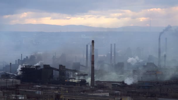 Luftförorening från industrianläggningar. Stor anläggning på bakgrund av staden. Rör kasta rök i himlen — Stockvideo