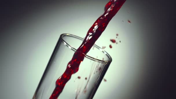 Red wine is poured into a glass — Stock Video