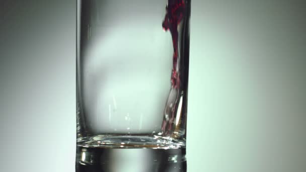 Cherry juice is poured into a glass — Stock Video