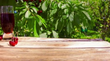 Wicker basket on the wooden table with beautiful fresh, ripe, juicy red cherry/cherries. 