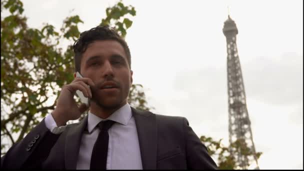 Ung attraktiv affärsman i svart kostym ringer ett samtal på en mobiltelefon — Stockvideo