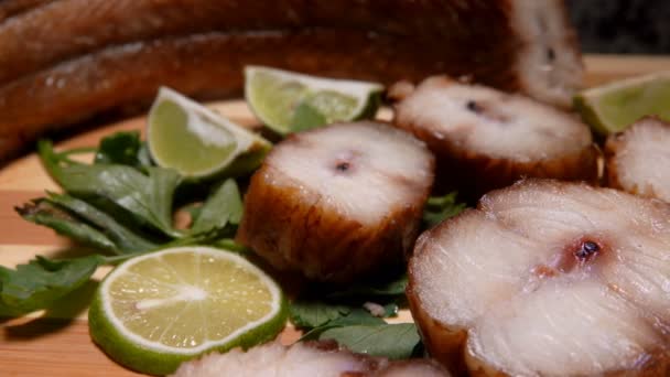 Panorama of smoked eel slices laying on a bamboo board — Stock Video