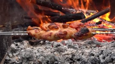 Ağız sulandıran tavuk kanatları açık ateşin üzerinde takla atıyor. 