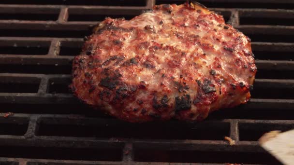 Top-up widok domowej roboty kotlet burger przerzucony na ruszcie grilla — Wideo stockowe
