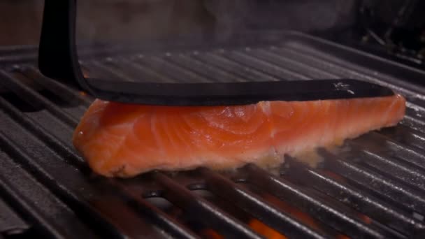 煮一块生鲑鱼片牛排，配上一个黑色的厨房锅铲 — 图库视频影像