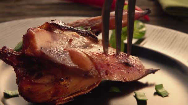 Close-up view of a fork taking away a piece of delicious fried quail — Stock Video