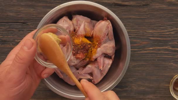 Top view of raw quails marinated in a bowl with mustard and spices — Stock Video