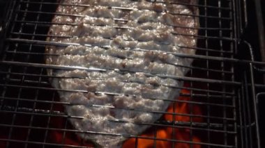 Sulu beyaz uskumru balığı ızgara ızgara ızgarasıyla ters çevrilmiş.