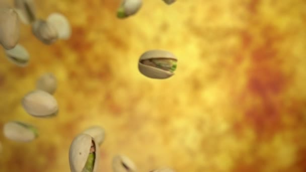 Sárga okker háttéren átlósan repülő sózott pisztáciák közelsége — Stock videók