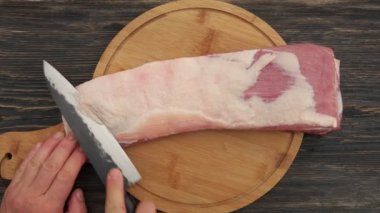 Erkek ellerinin mangal için çiğ kaburga yağlarını keserken üst görüntüsü.