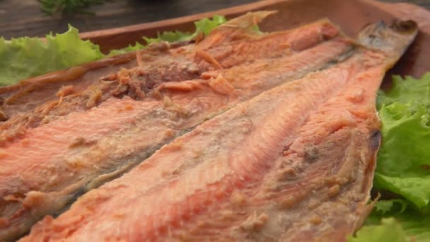 Panorama of the juicy grilled red char fish on the wooden plate — Stock Video