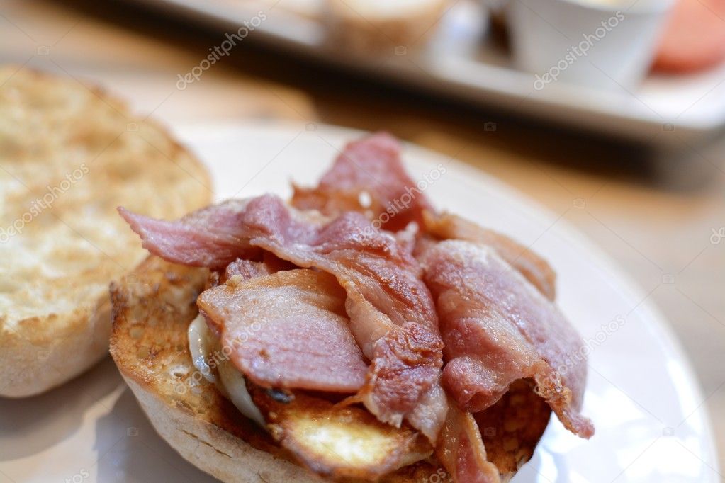 A Breakfast Crispy Bacon Ciabatta and Egg served on a white plate