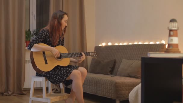 Young girl playing the guitar at home — Stock Video