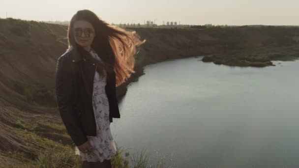 Beautiful female enjoying nature outdoors. Lake at background. Freedom concept. — Stock Video