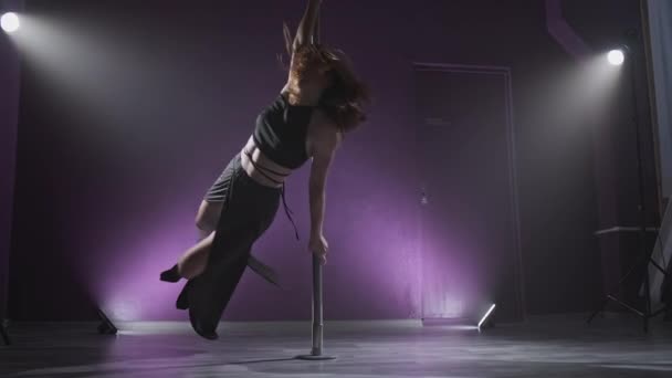 Sexy Frau Pole Dance in dunklem Interieur mit Licht und Rauch. Junges schlankes Mädchen — Stockvideo