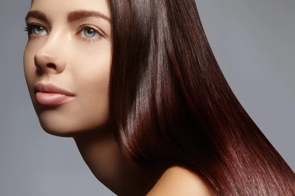 Hermosa mujer joven con la piel limpia, hermoso cabello liso brillante, maquillaje de moda. Maquillaje de glamour, cejas de forma perfecta. Retrato morena sexy. Hermoso peinado suave — Foto de Stock