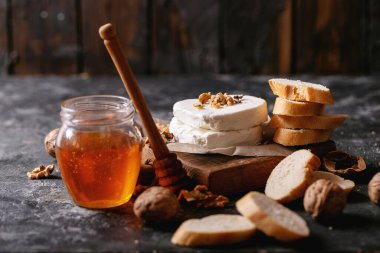 Koyu dokuda bal ve cevizle servis edilen keçi peyniri. Boşluğu kopyala