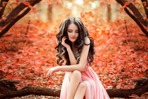 Lady in a luxury lush pink pastel dress sits near the tree,fantastic shot,fairytale princess is walking in the autumn forest,fashionable toning,creative computer colors