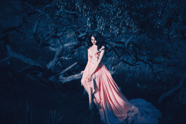 Lady in a luxury lush pink pastel dress near the tree,fantastic shot,fairytale princess is walking in the autumn forest,fashionable toning,creative computer colors