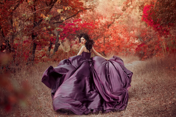Lady in a luxury lush purple dress ,fantastic shot,fairytale princess is walking in the autumn forest,fashionable toning,creative computer colors